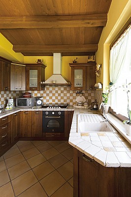 Copertura con travi e tavolato in rovere, rivestimento top cucina con tozzetti di marmo anticato I Sassi di Assisi